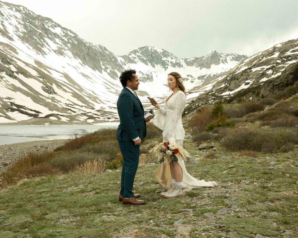 Erin and Josh officially eloping in the mountains of colorado in their wedding outfits. 